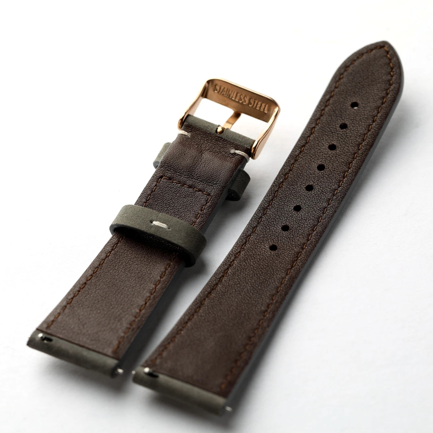 A dark brown leather watch strap with a rose gold buckle and a dark green loop, displayed on a clean white background.