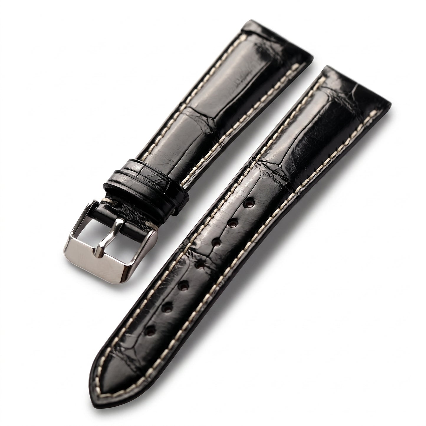 Black alligator leather watch strap with light beige contrast stitching and a silver-toned metal buckle, shown on a clean white background.