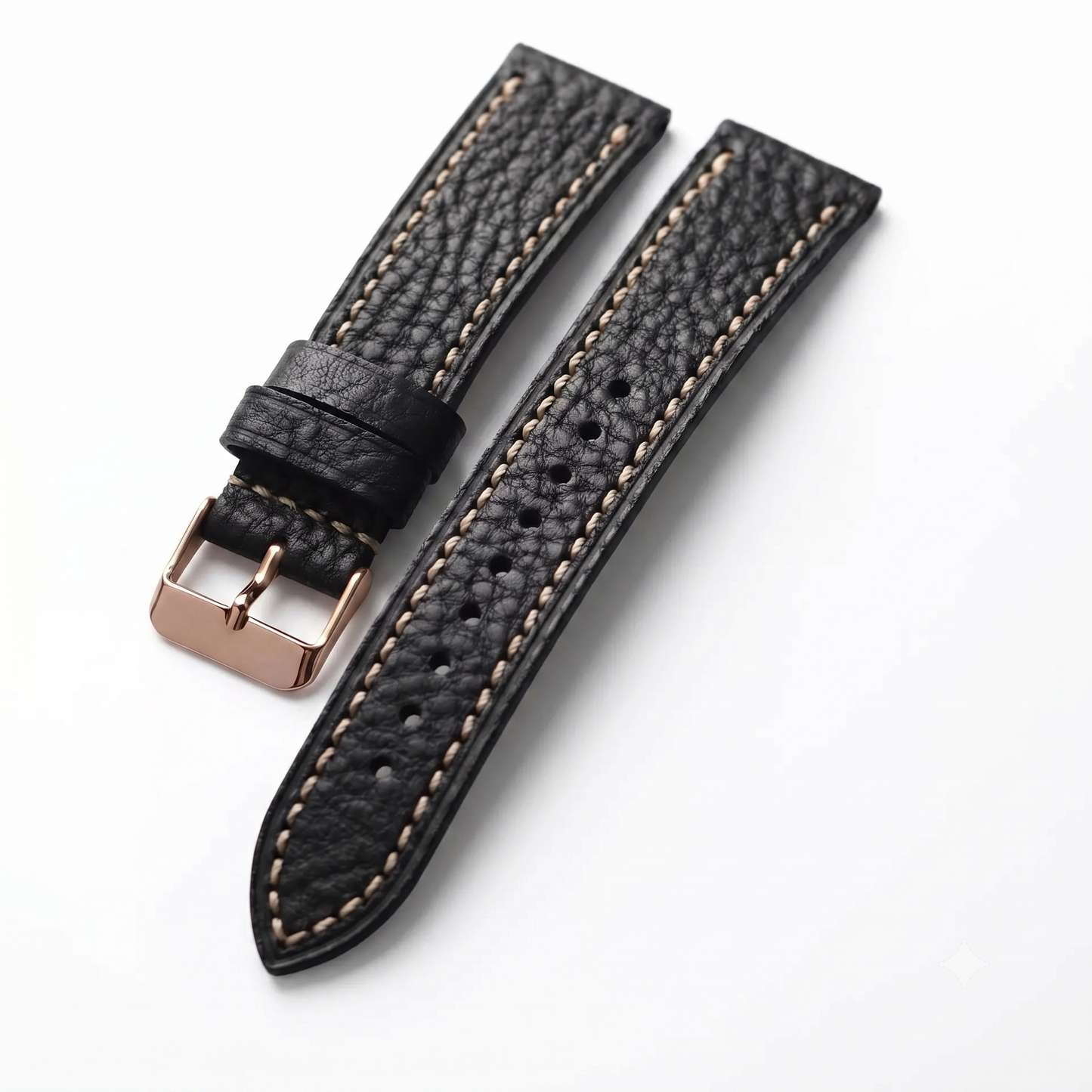 Black leather watch strap with rose gold buckle on a white background