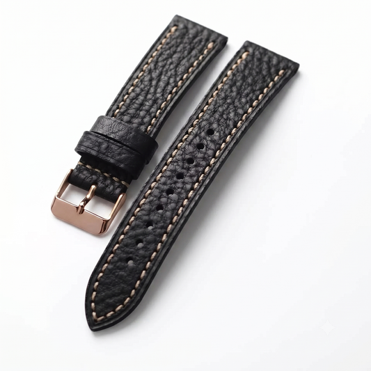 Black leather watch strap with rose gold buckle on a white background