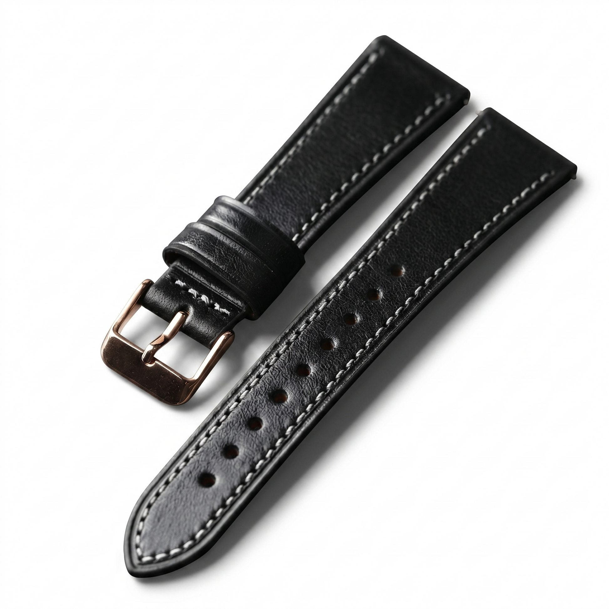 Black leather watch strap with gold buckle on a white background