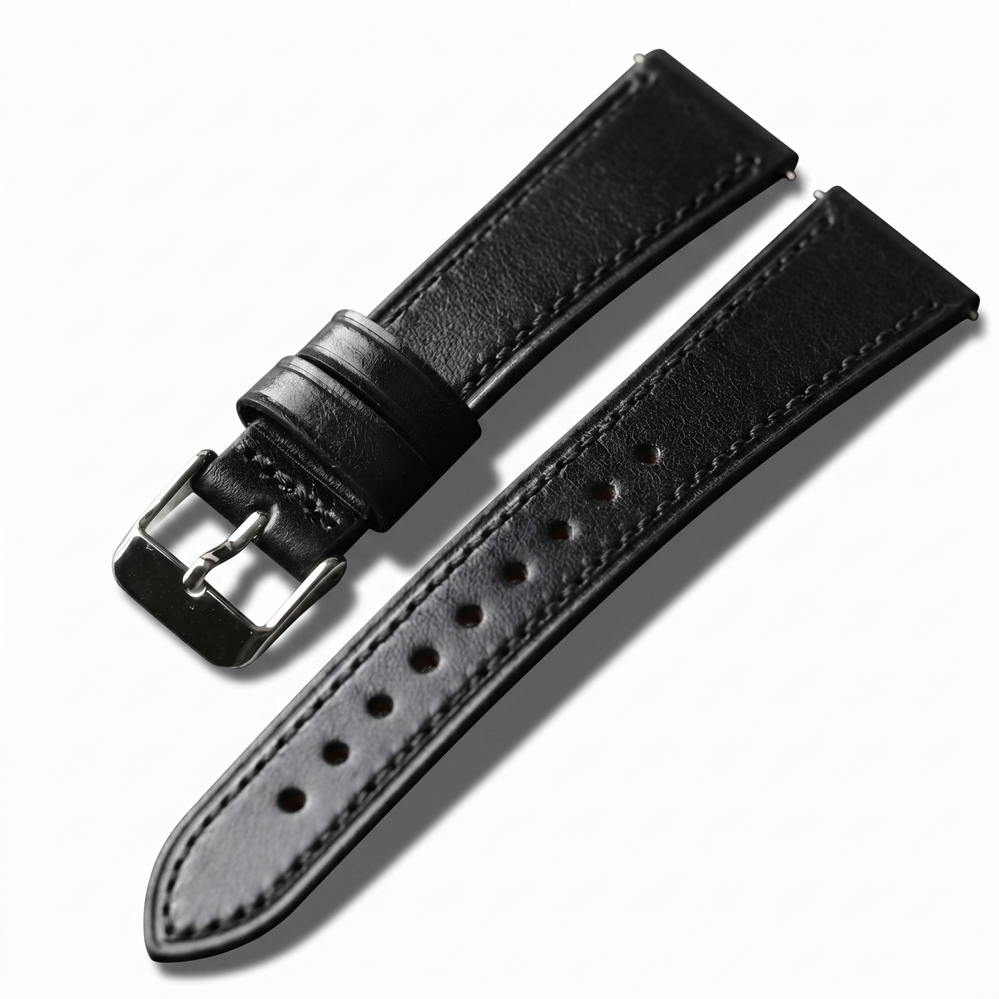 Black leather watch strap with silver buckle on a white background