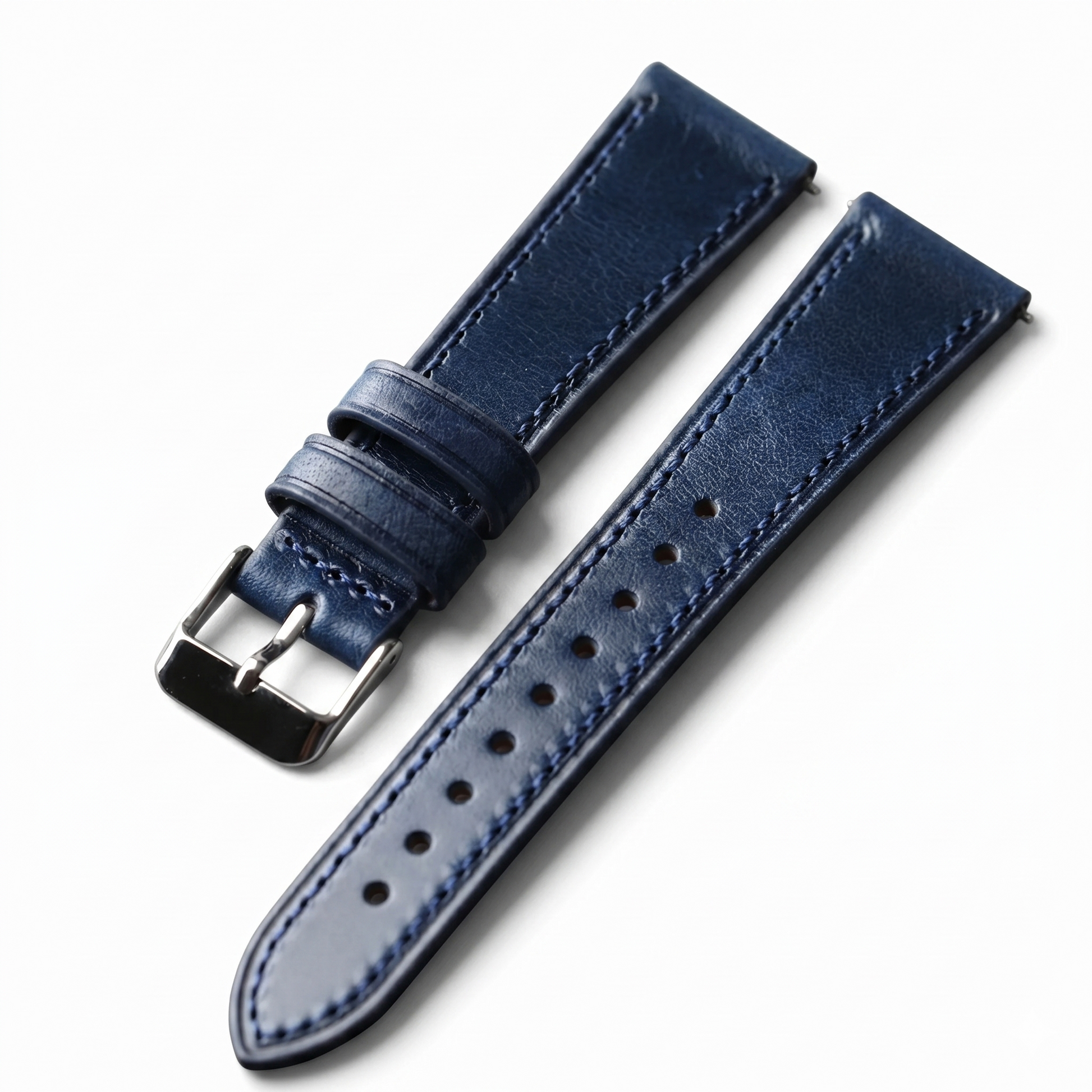Blue leather watch strap with silver buckle on a white background