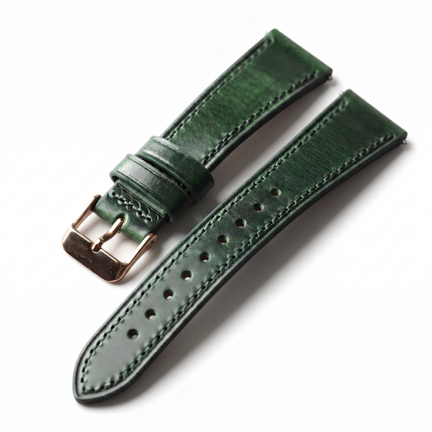 Green leather watch strap with rose gold buckle on a white background