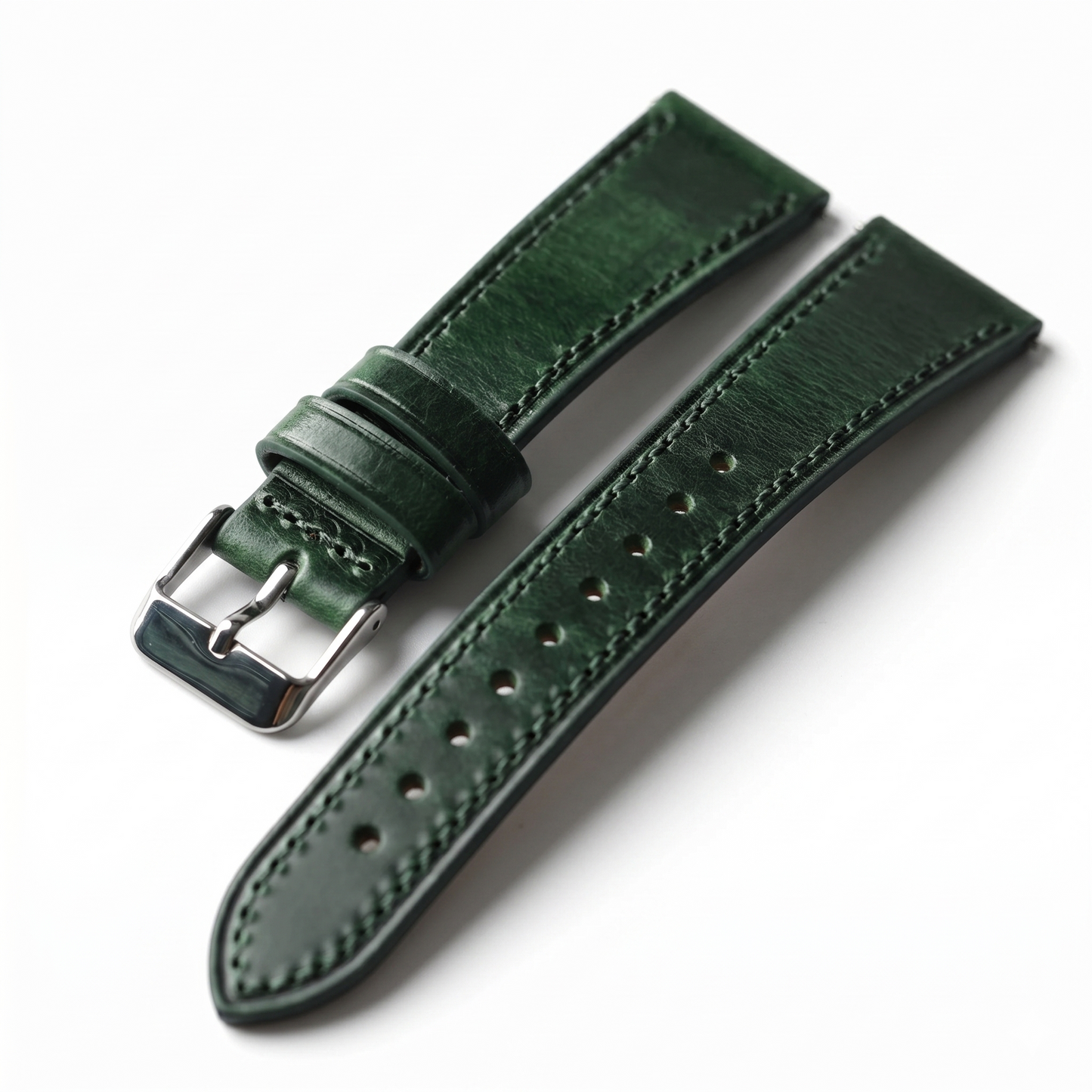 Green leather watch strap with silver buckle on a white background