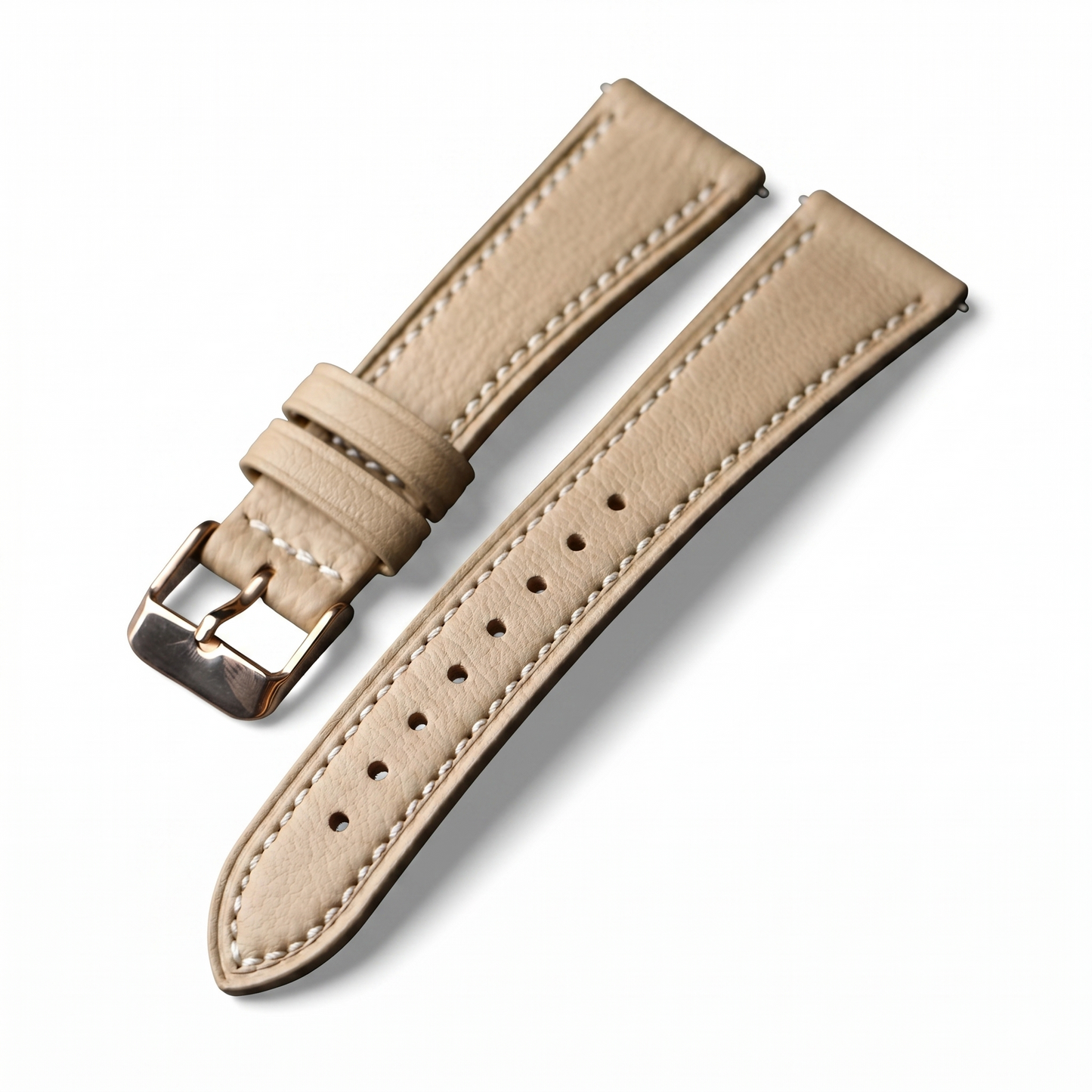 Beige leather watch strap with silver buckle on a white background