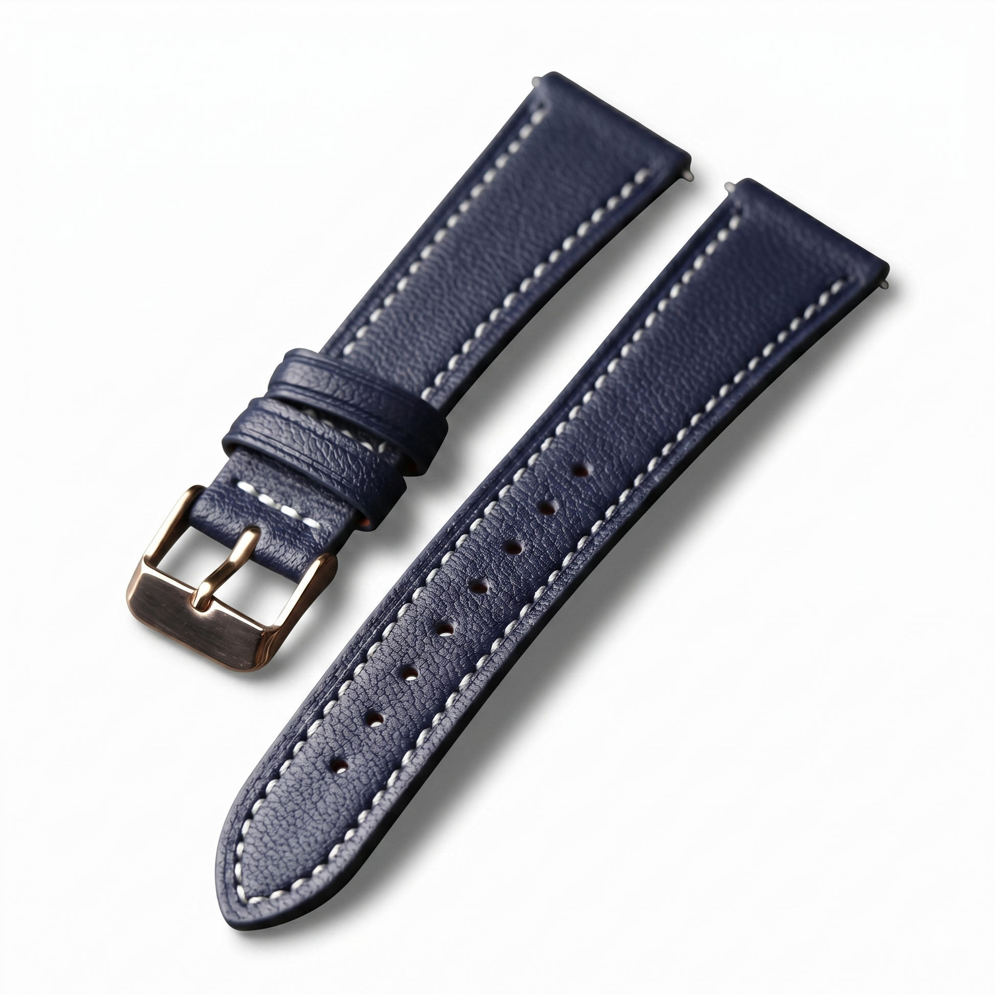 Navy blue leather watch strap with white stitching on a white background