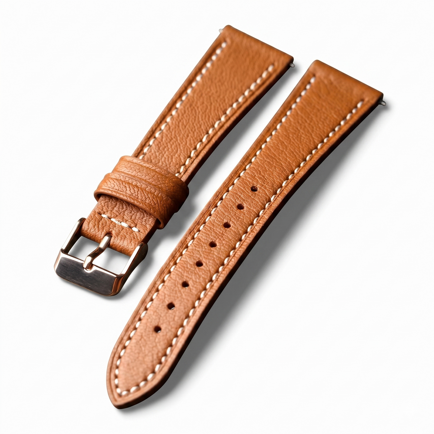 Brown leather watch strap with silver buckle on a white background