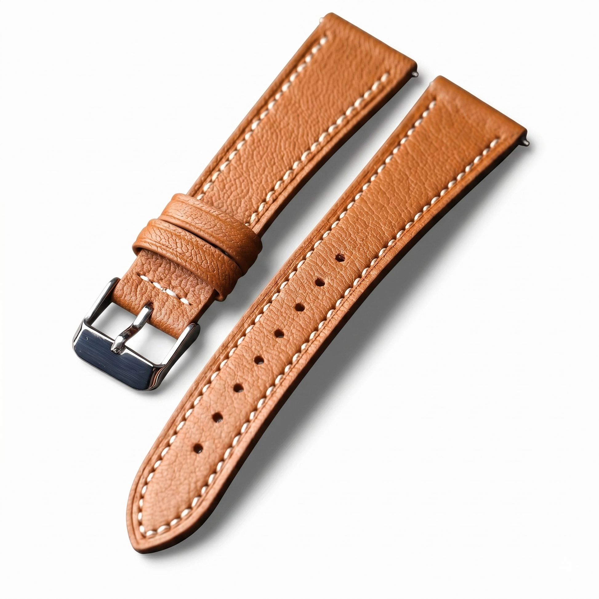 Brown leather watch strap with silver buckle on a white background