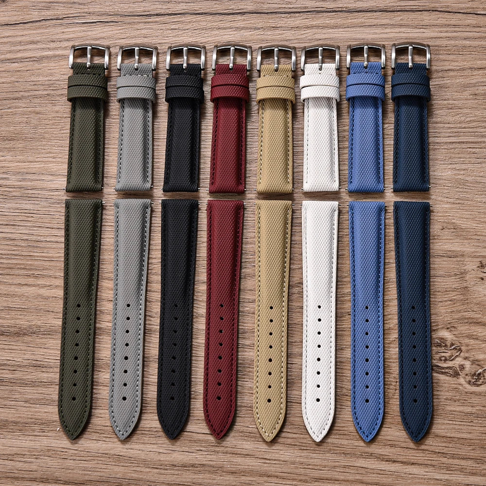 Set of various watch straps in different colors on a wooden surface