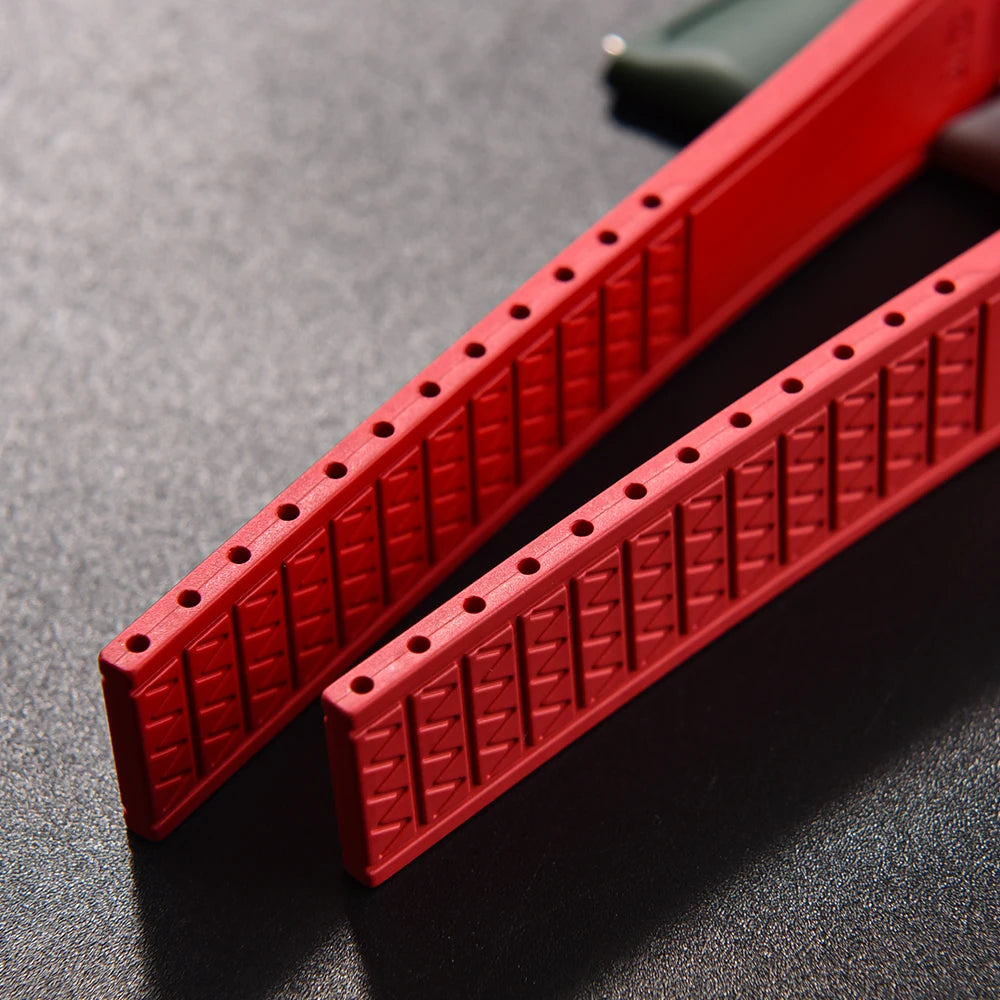 Two red plastic strips with a textured surface on a dark gray background