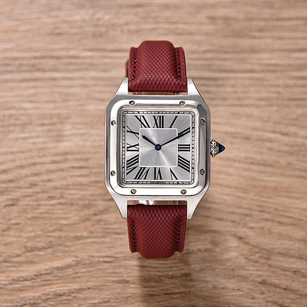 Watch with a red strap on a wooden surface
