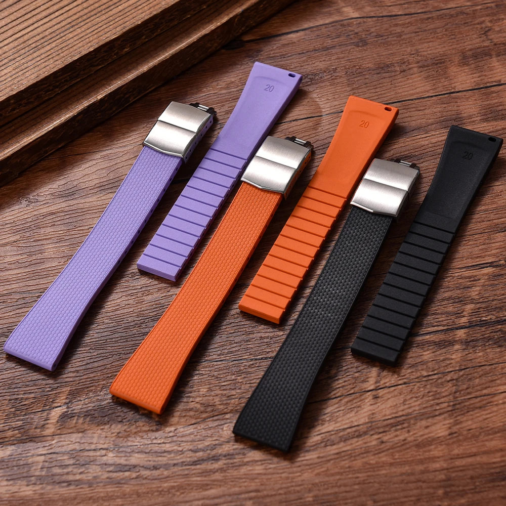 Four colorful watch straps on a wooden surface