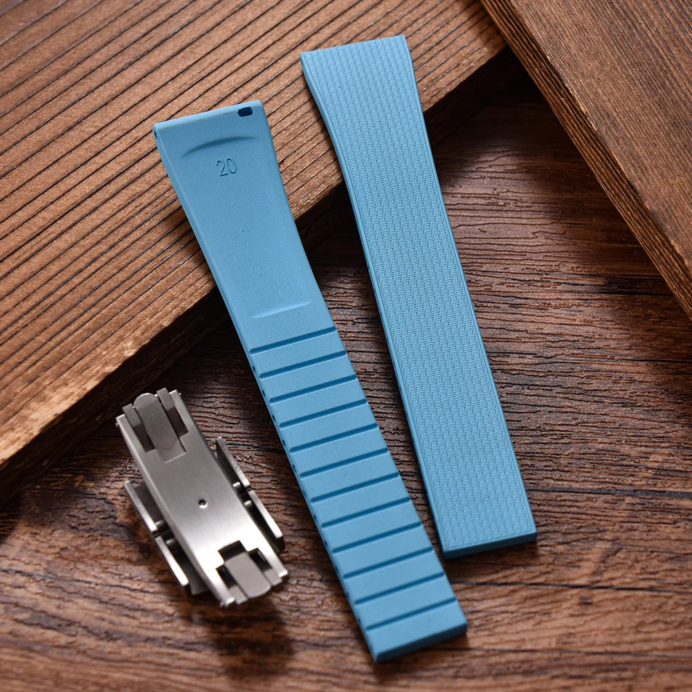 Blue watch strap with metal clasp on a wooden surface
