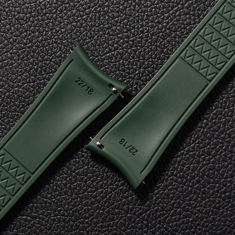 Green watch strap with embossed pattern on a textured black background