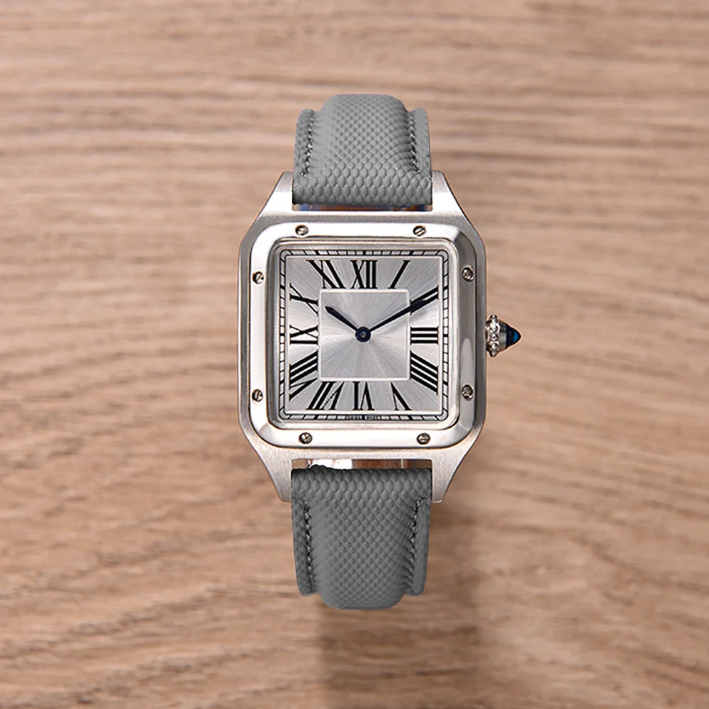 Gray wristwatch with a silver case on a wooden surface