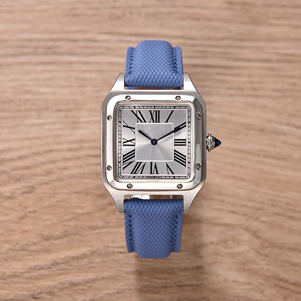Watch with blue strap and silver case on a wooden surface