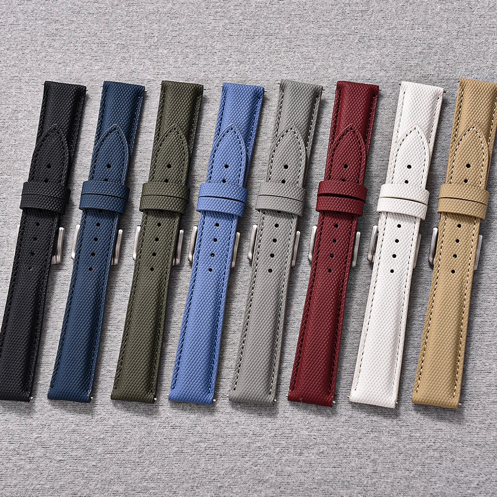 Set of eight watch straps in various colors on a gray background