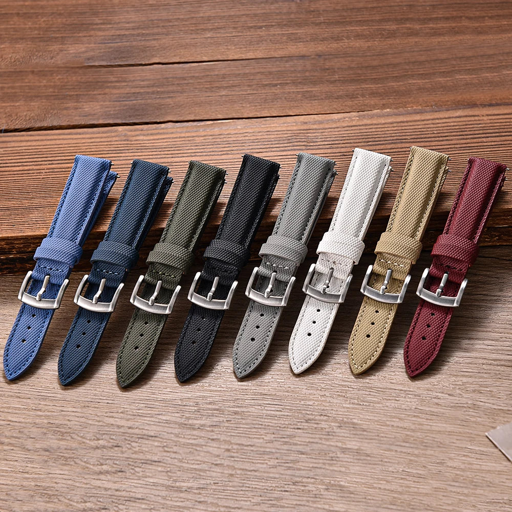 Set of eight watch straps in various colors on a wooden surface