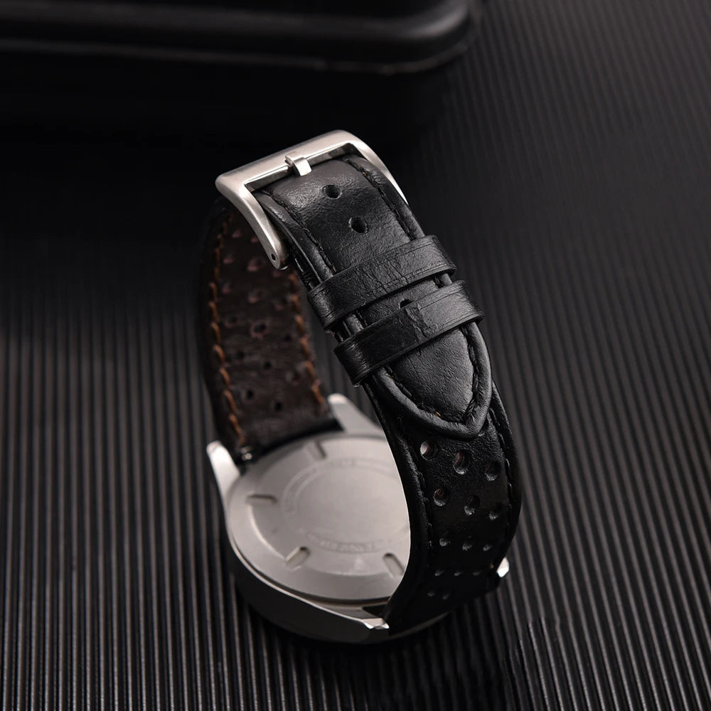 Black textured watch strap on a dark textured surface