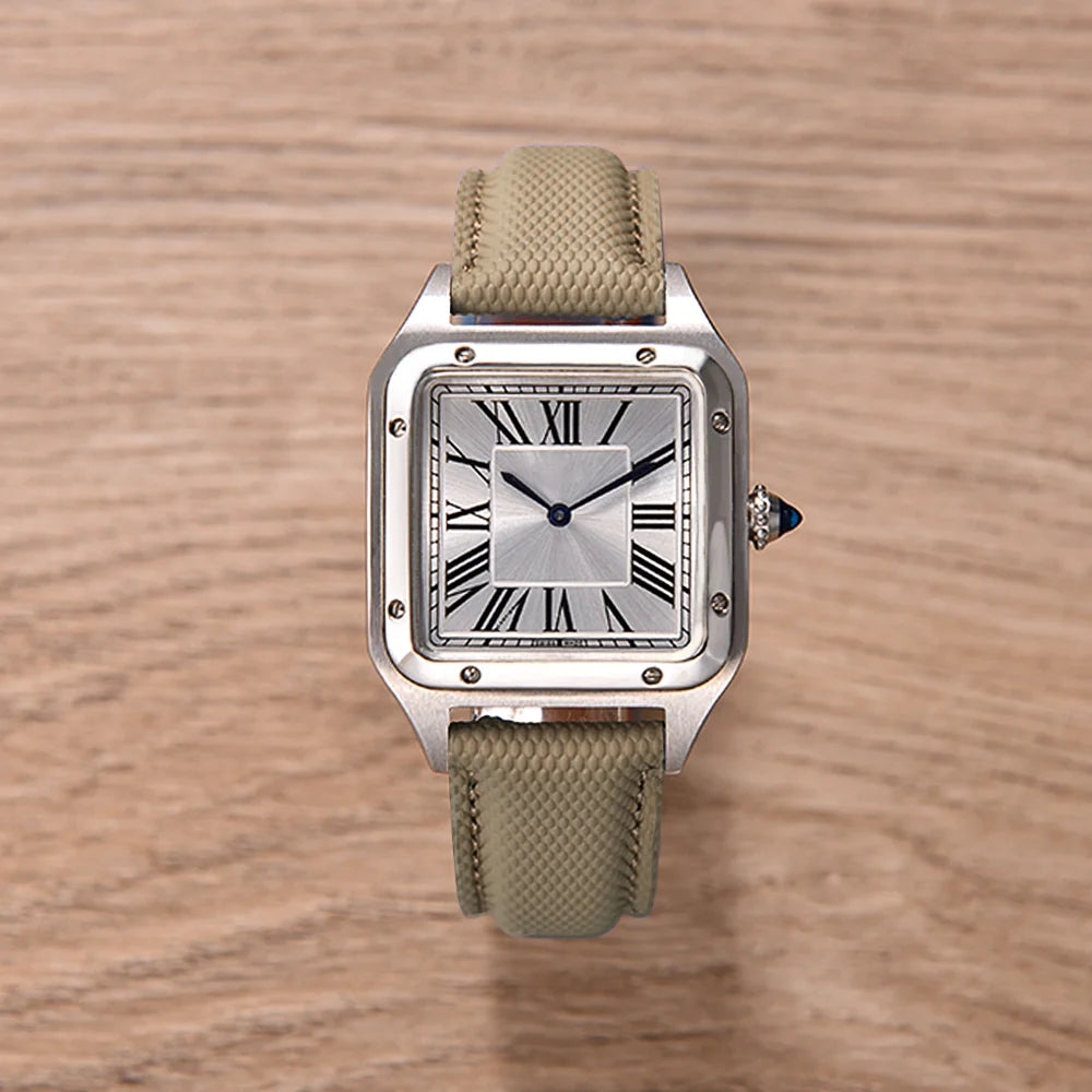 Watch with a beige strap on a wooden surface