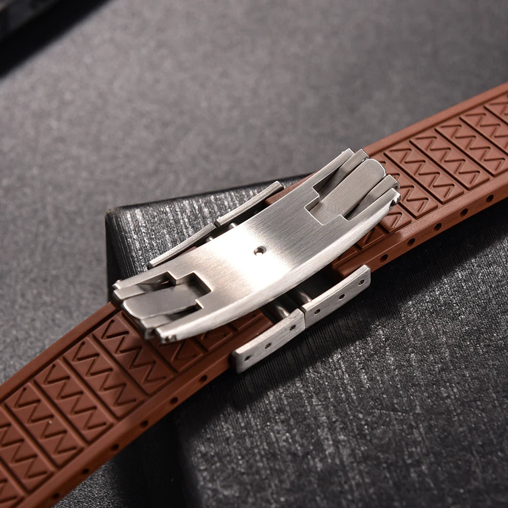 Brown leather watch strap with silver buckle on a dark textured background