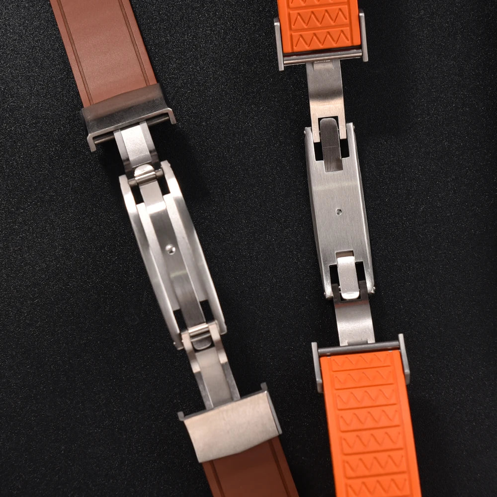 Two watch straps with brown and orange ends on a black background