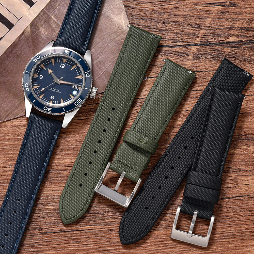 Watch with three different straps on a wooden surface