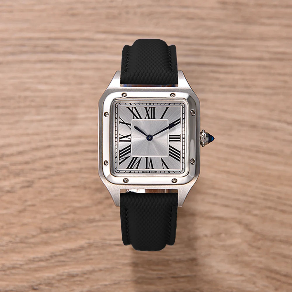 Watch with black strap and silver case on a wooden surface