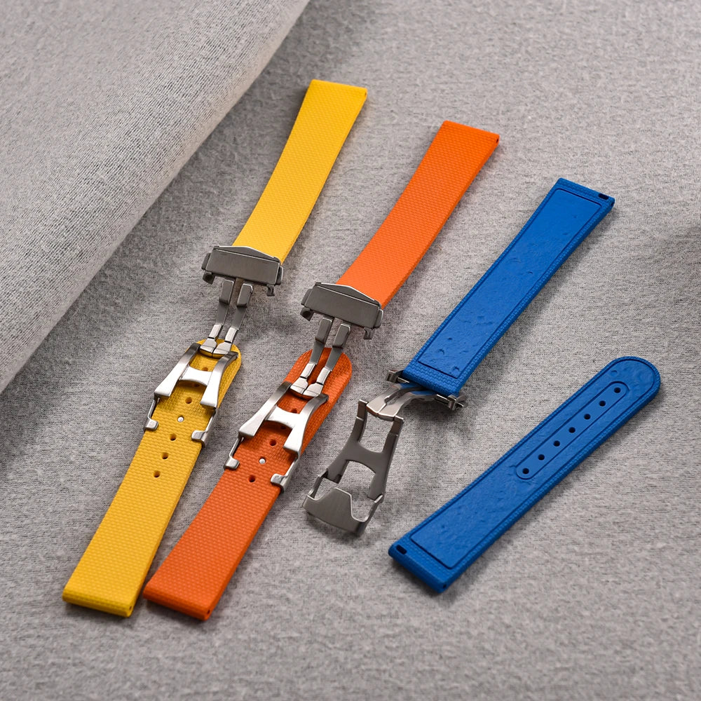 Set of colorful watch straps on a gray surface