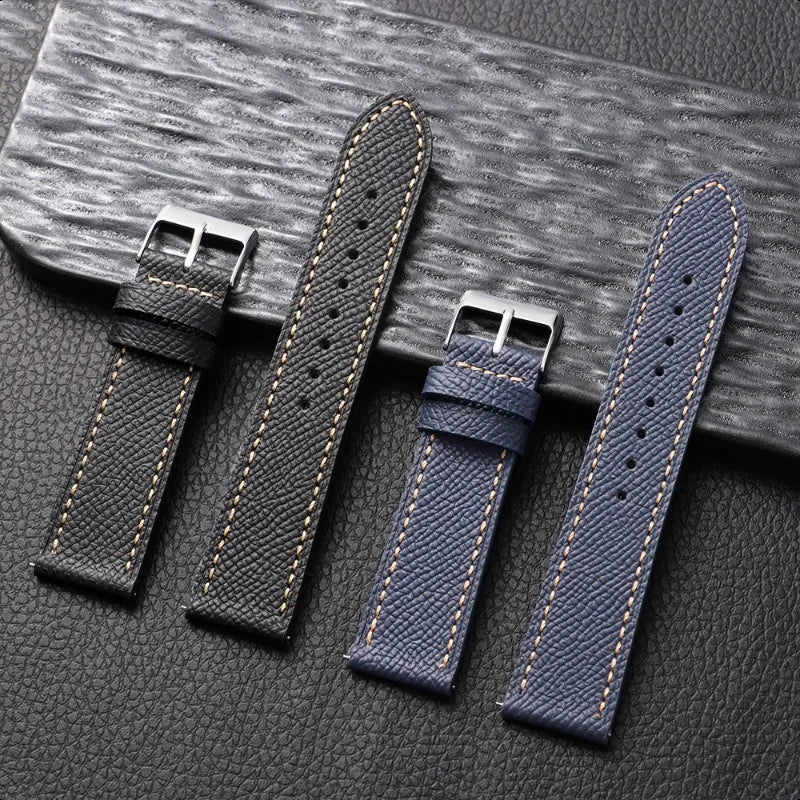 Four watch straps on a textured surface