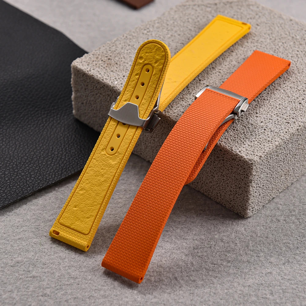 Yellow and orange watch straps on a textured surface